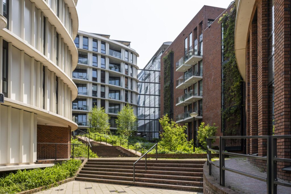 Modern apartment buildings with green landscaping at Bos en Lommerplein in Amsterdam.